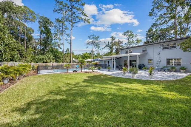 a swimming pool view with a seating space