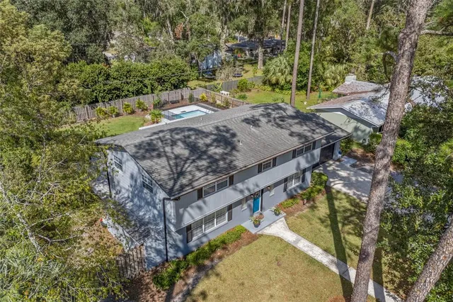 view of a house with a yard and sitting area