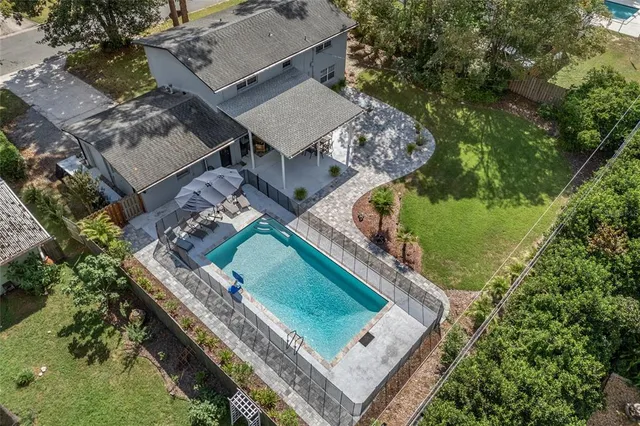 an aerial view of a house with a garden and swimming pool