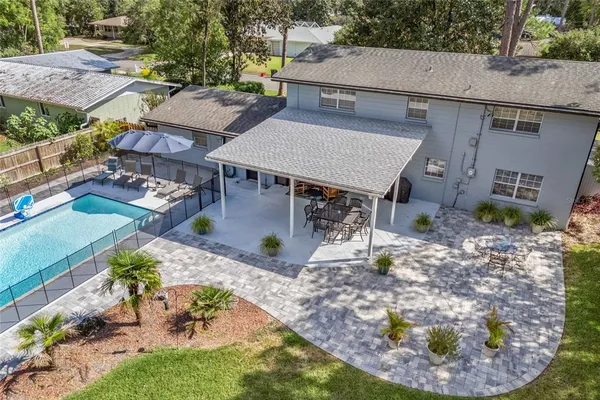 an aerial view of a house with yard