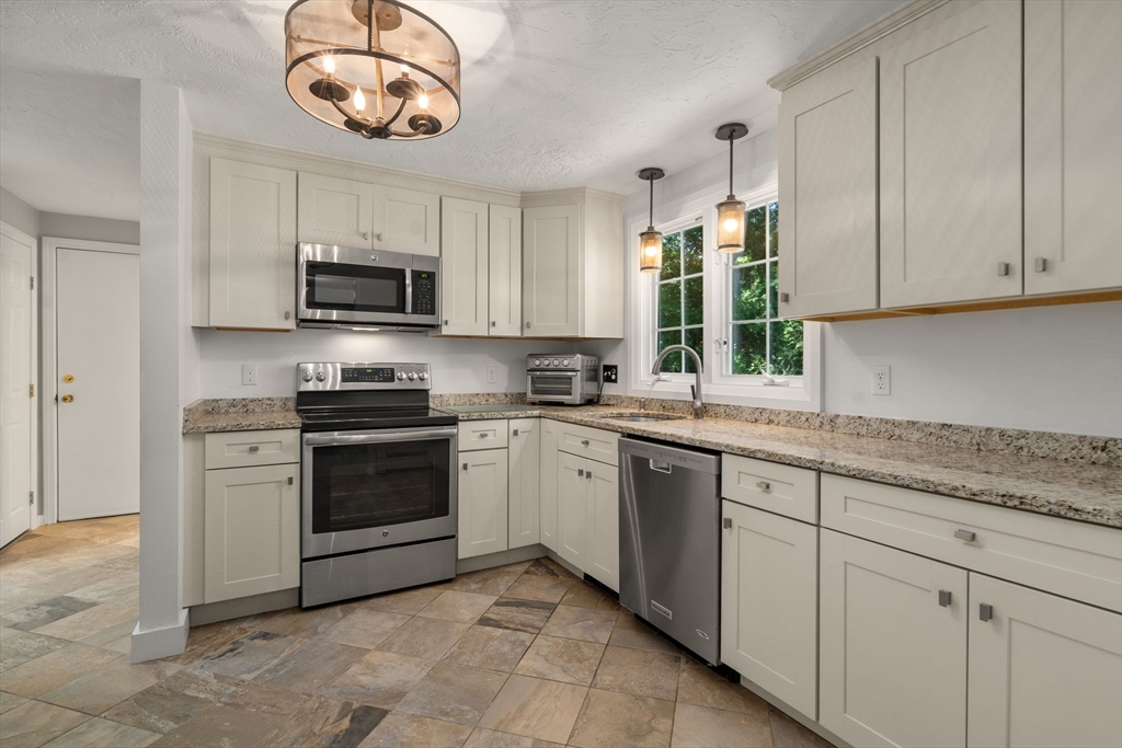 15 Mockingbird Lane Maynard, MA 01754 - Photo 16 of 31 a kitchen with cabinets stainless steel appliances a sink and a window