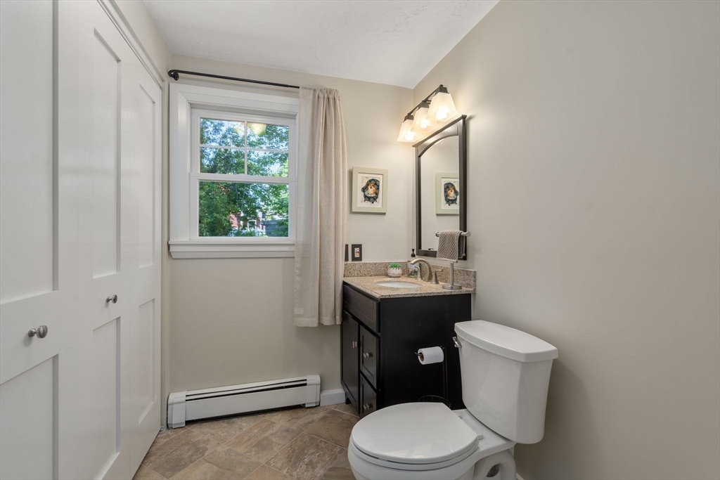 15 Mockingbird Lane Maynard, MA 01754 - Photo 17 of 31 a bathroom with a toilet sink vanity and mirror