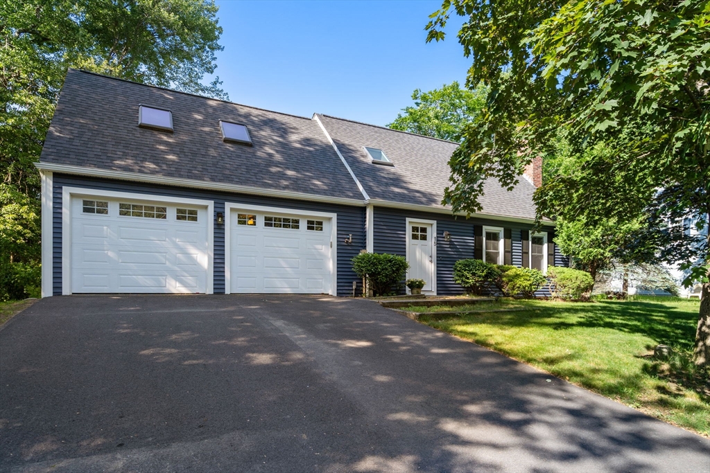15 Mockingbird Lane Maynard, MA 01754 - Photo 2 of 31 a front view of a house with a yard and garage