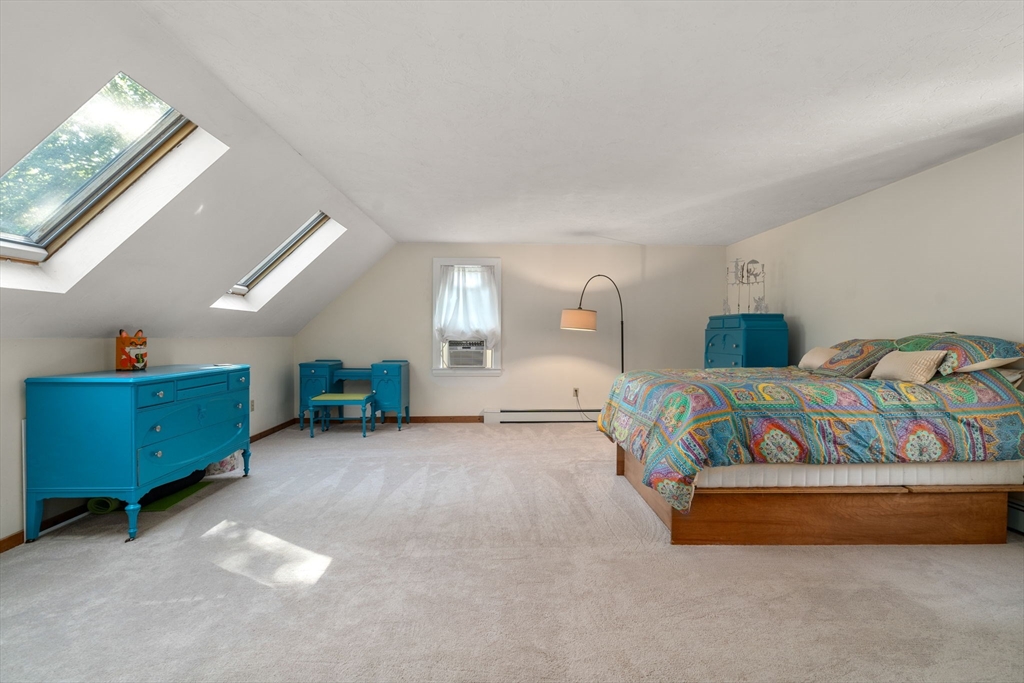 15 Mockingbird Lane Maynard, MA 01754 - Photo 24 of 31 a spacious bedroom with a bed and a chandelier