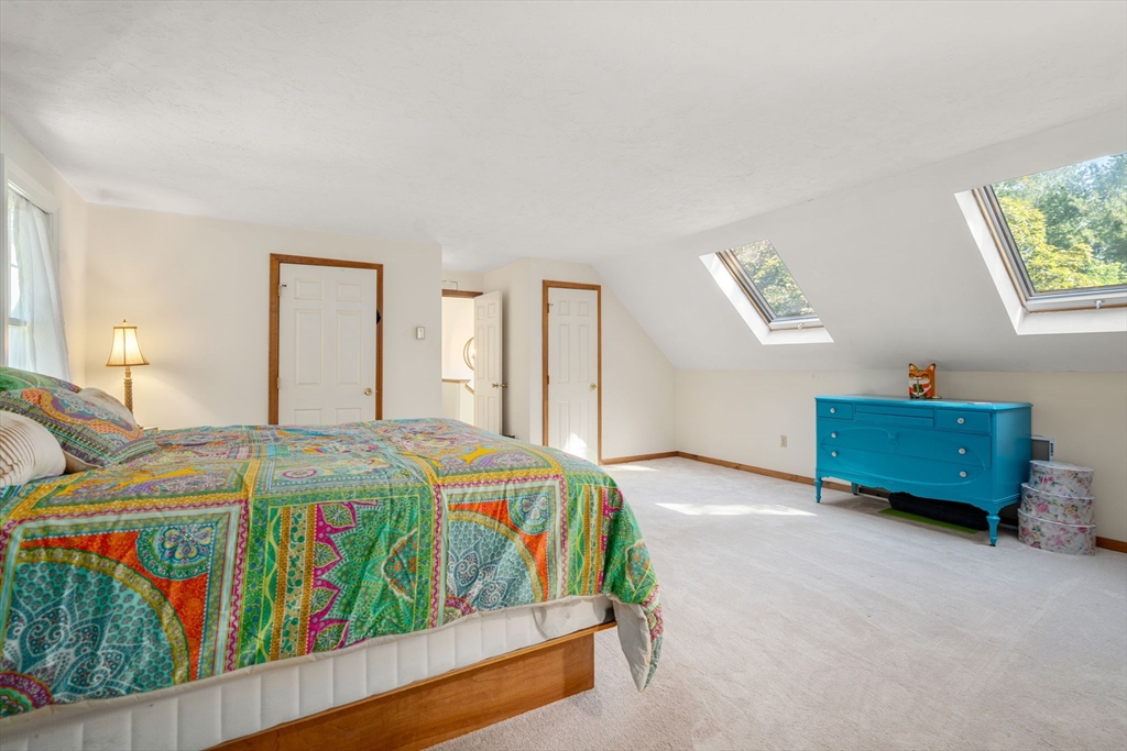 15 Mockingbird Lane Maynard, MA 01754 - Photo 26 of 31 a bed room with a bed and a couch