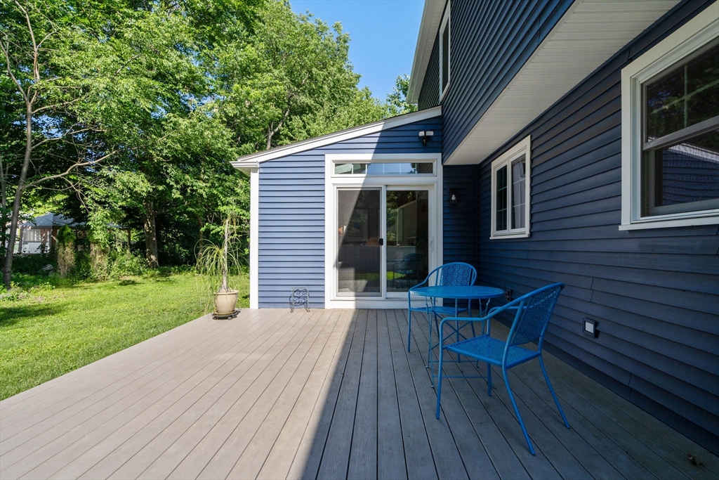 15 Mockingbird Lane Maynard, MA 01754 - Photo 30 of 31 a view of a patio with table and chairs with wooden floor and fence