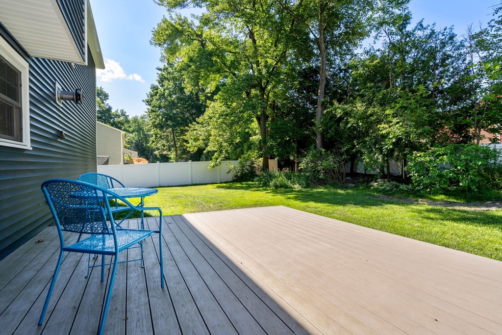 15 Mockingbird Lane Maynard, MA 01754 - Photo 31 of 31 a view of a deck with table and chairs and wooden floor