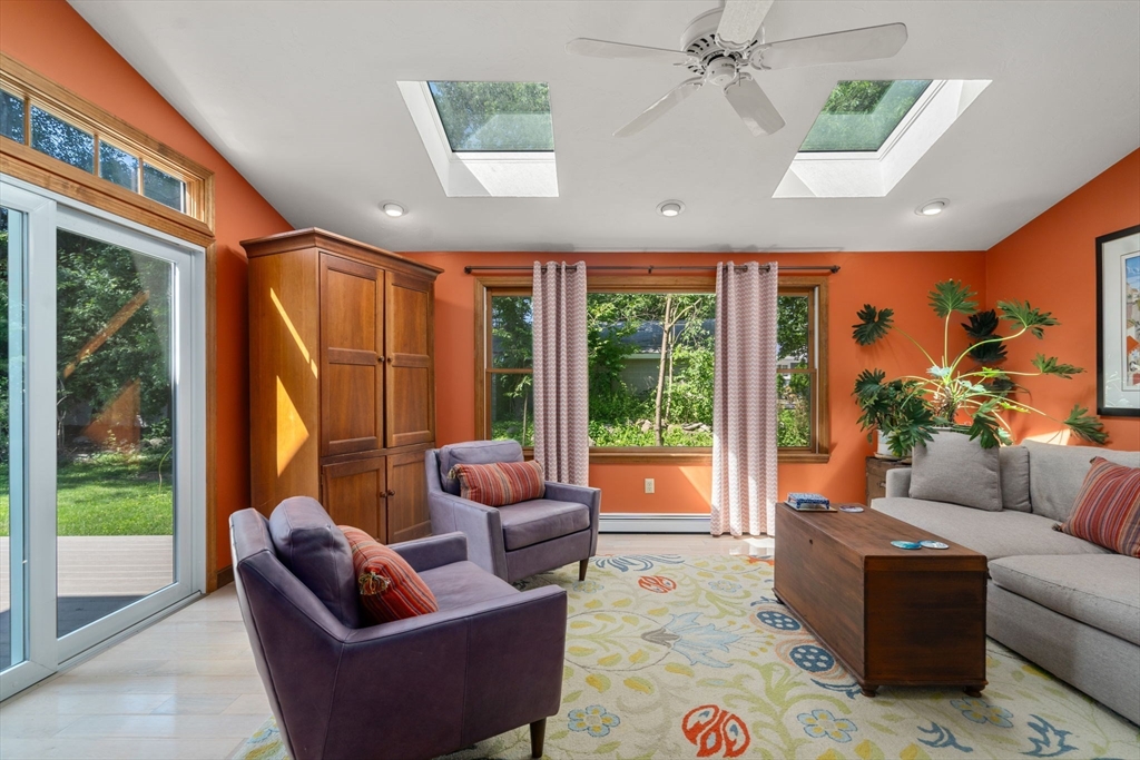 15 Mockingbird Lane Maynard, MA 01754 - Photo 4 of 31 a living room with furniture a ceiling fan and a floor to ceiling window