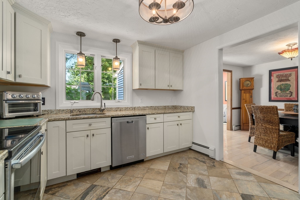 15 Mockingbird Lane Maynard, MA 01754 - Photo 9 of 31 a kitchen with a stove a sink and a refrigerator