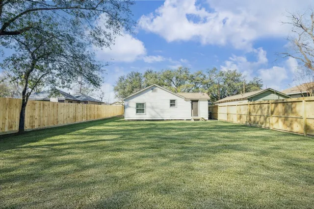 a big house with a big yard and large trees