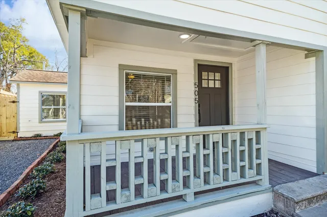 a view of a brick house with a porch