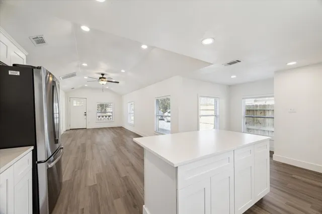 a large kitchen with sink a refrigerator and a stove