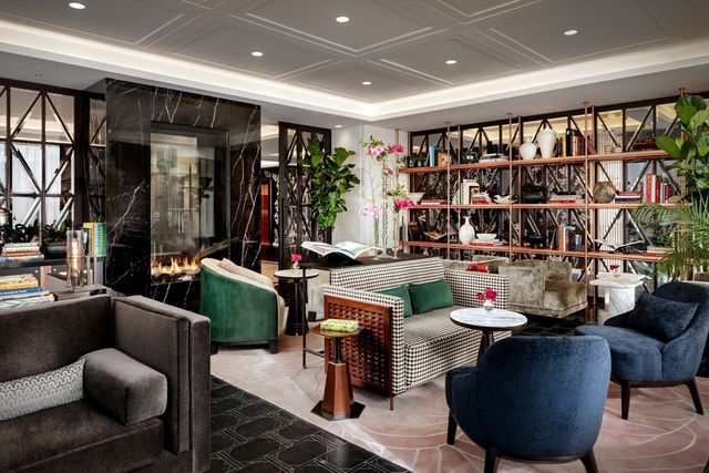 a view of a dining room with furniture and chandelier