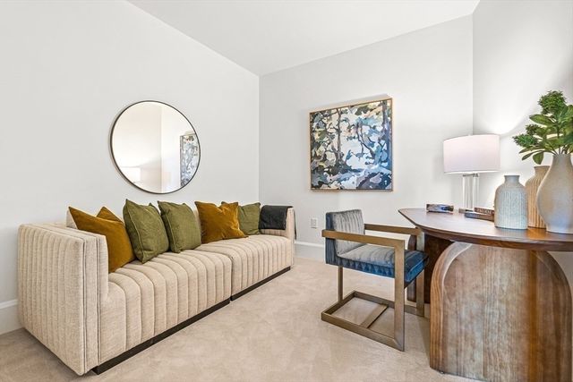 a living room with furniture and a lamp