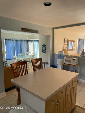 a kitchen with a table chairs and a refrigerator