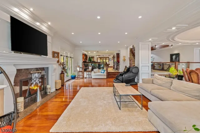 a living room with furniture a wooden floor and a flat screen tv