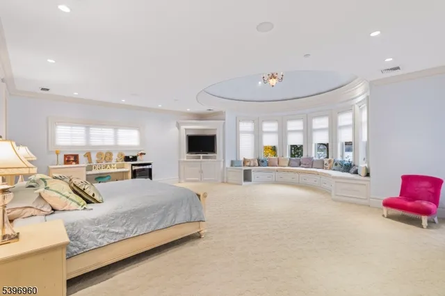 a living room with furniture and a mirror