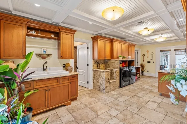 a kitchen with stainless steel appliances kitchen island granite countertop a refrigerator and a stove top oven
