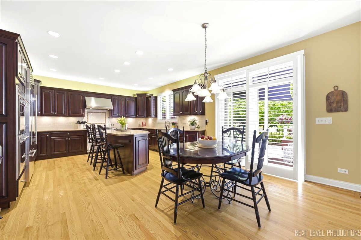 1914 North Ridge Avenue Arlington Heights, IL 60004 - Photo 15 of 50 a view of a dining room and livingroom with furniture wooden floor a chandelier