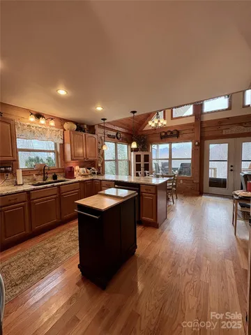 a kitchen with wooden floors and wooden cabinets