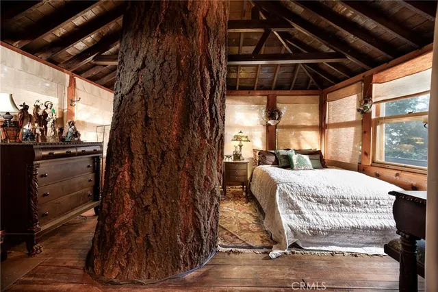 a bed sitting in a bedroom next to a window