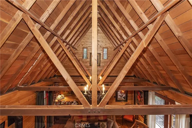 a bed room with a bed and a view of kitchen