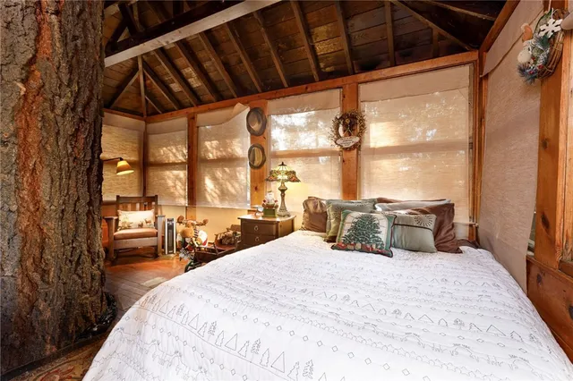 a large bedroom with a bed and large windows