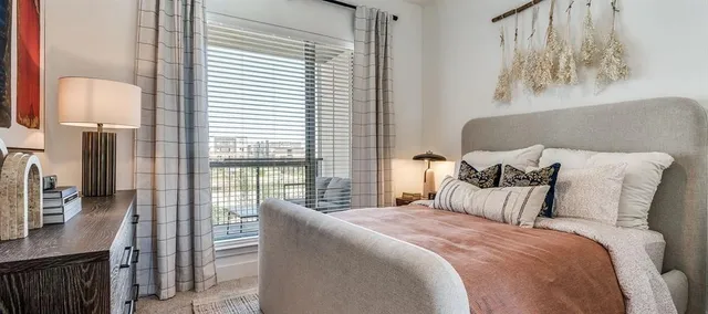 a bedroom with bed and a night stand