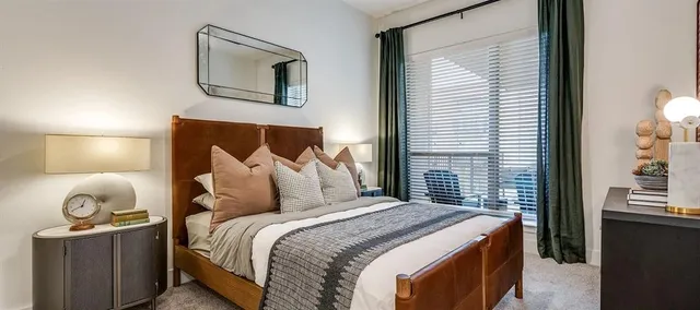 a bedroom with a bed and lamp