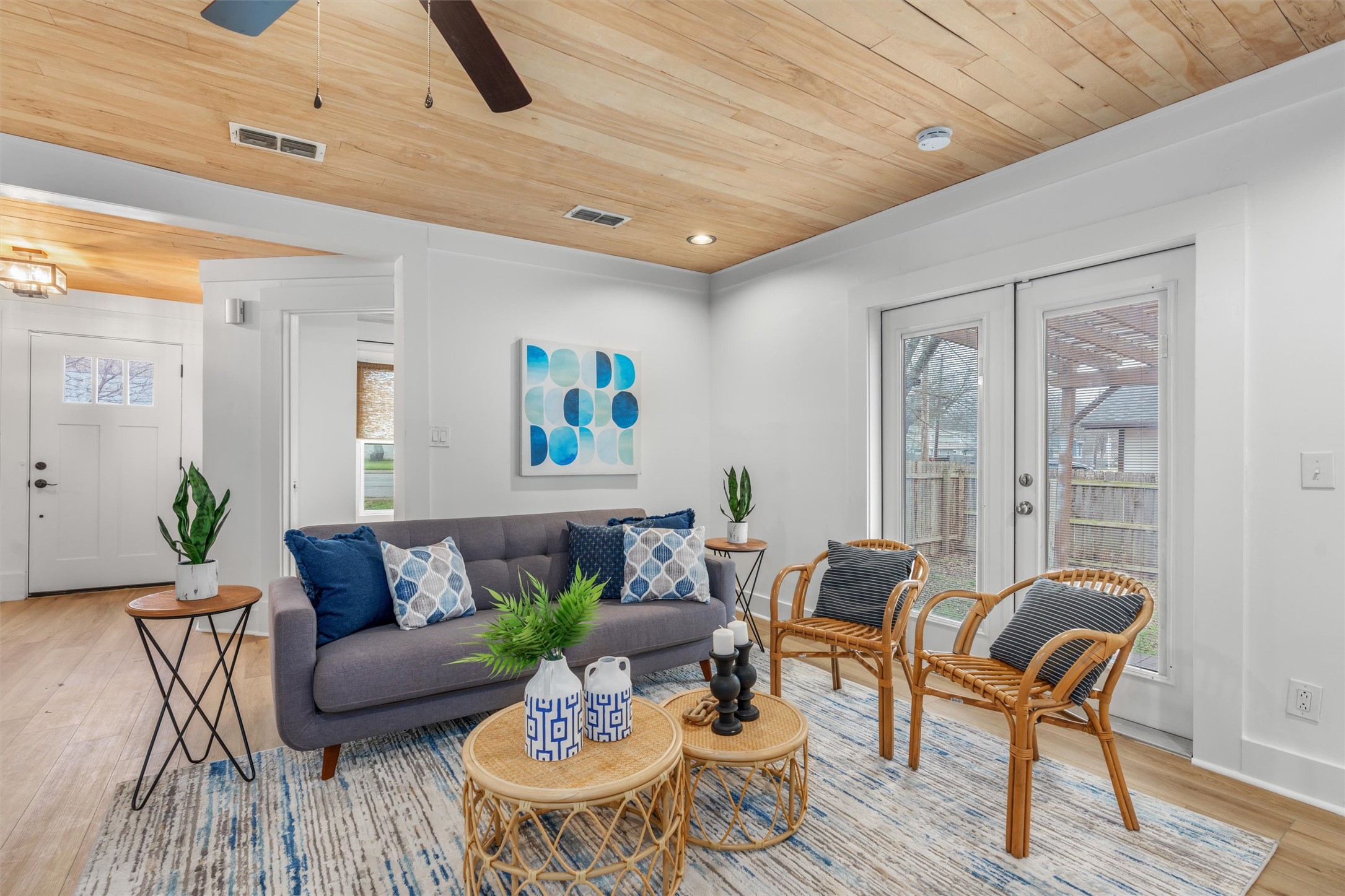 a living room with furniture and wooden floor