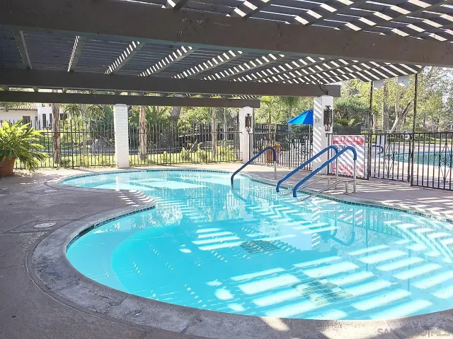a view of a swimming pool with a patio