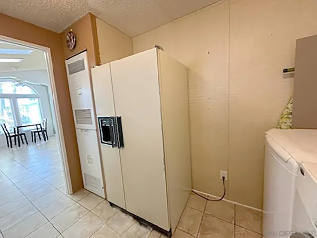 a refrigerator freezer sitting inside of a kitchen