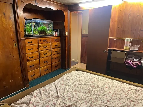 a view of a bedroom with wooden floor and small space
