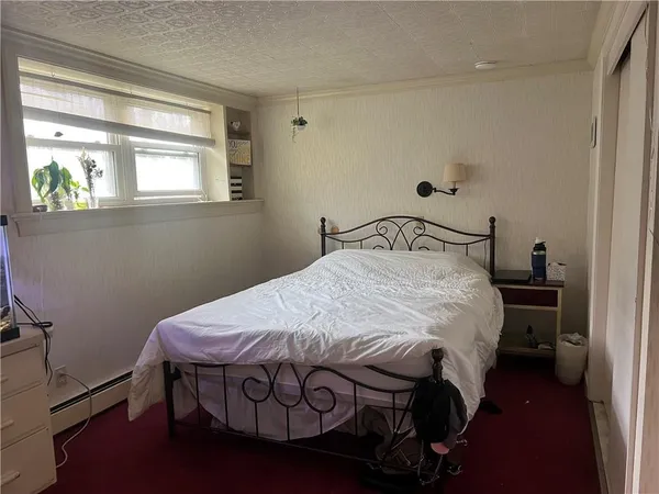 a bedroom with a bed and a window