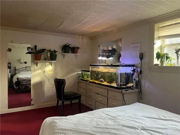 a bedroom with a bed and a chair