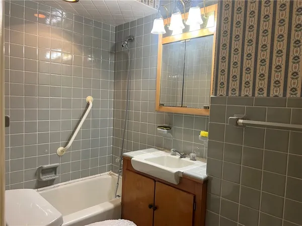 a bathroom with a sink toilet shower and bathtub