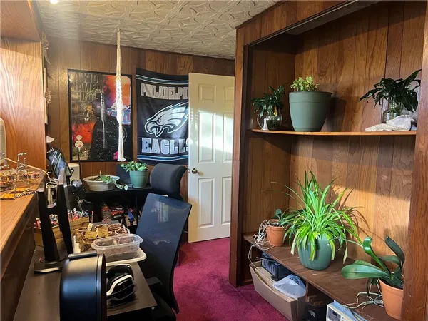 a dining room with furniture and potted plant