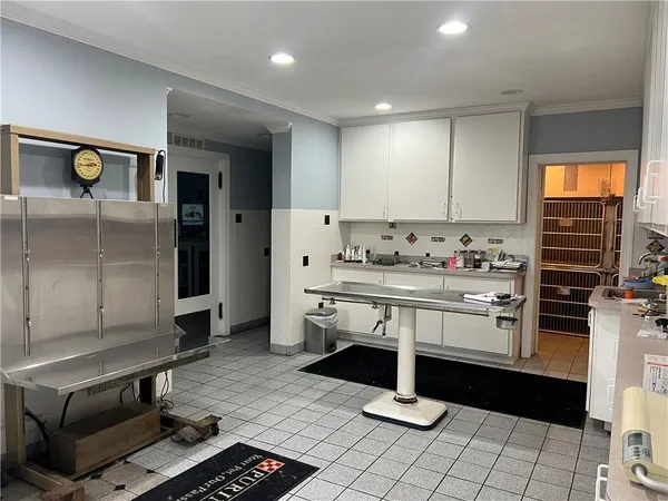 a kitchen with stainless steel appliances kitchen island granite countertop a stove a sink and a refrigerator