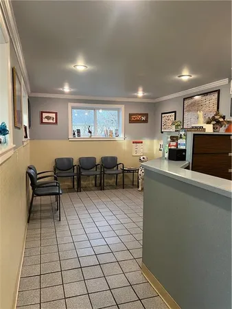a living room with lots of furniture and a view of kitchen