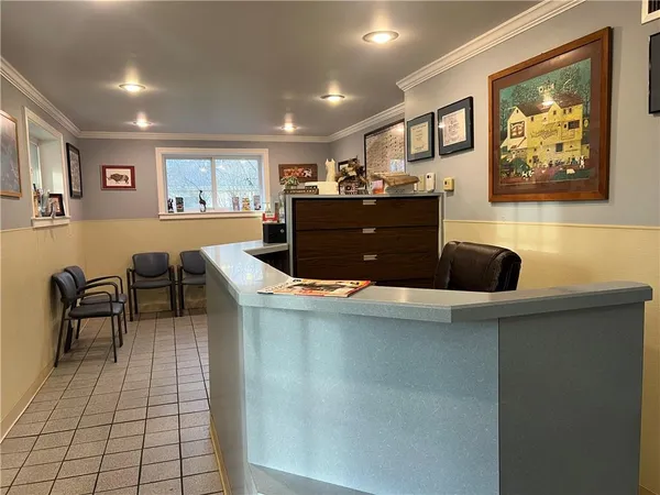 a view of kitchen with windows and refrigerator