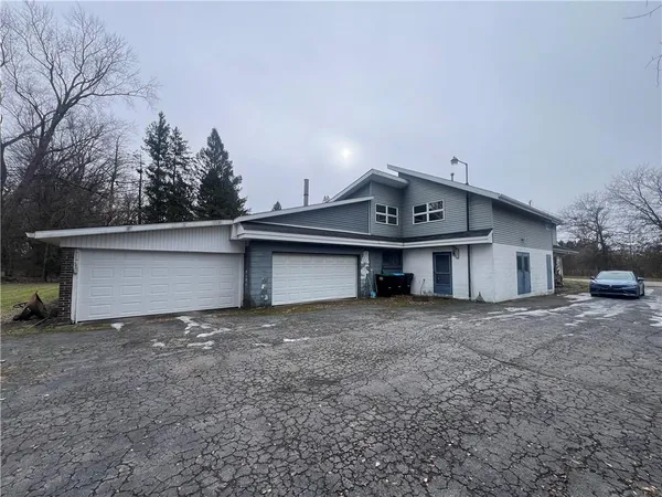 a view of a house with a yard and garage