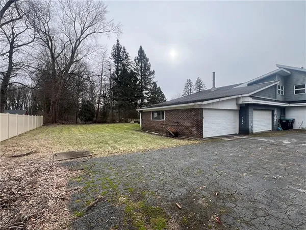 a view of a house with a yard and garage