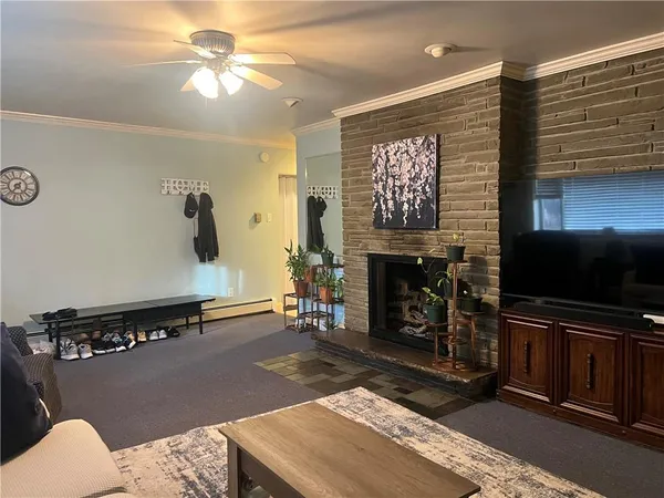 a living room with furniture a flat screen tv and a fireplace