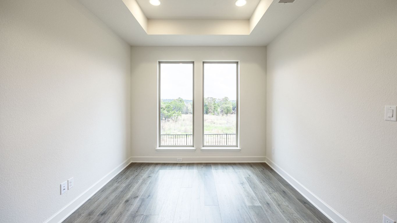 1517 Rodeo Ridge Drive Georgetown, TX 78628 - Photo 11 of 39 an empty room with wooden floor and windows