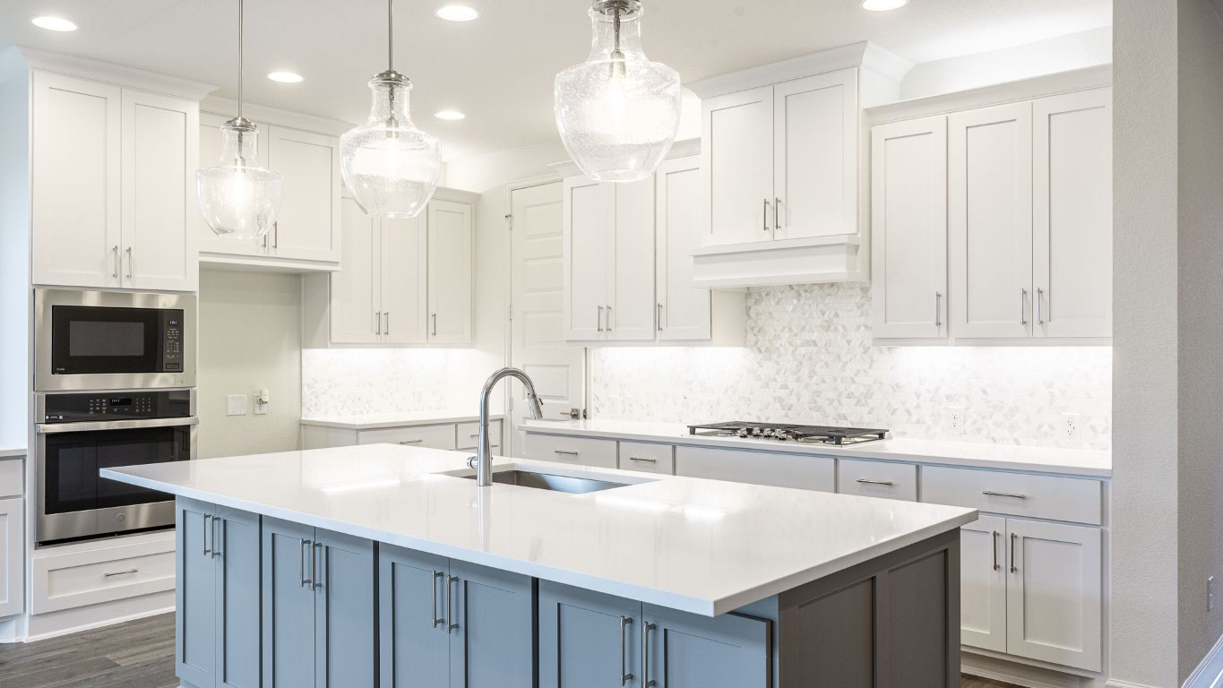 1517 Rodeo Ridge Drive Georgetown, TX 78628 - Photo 7 of 39 a kitchen with a sink a center island stainless steel appliances and cabinets