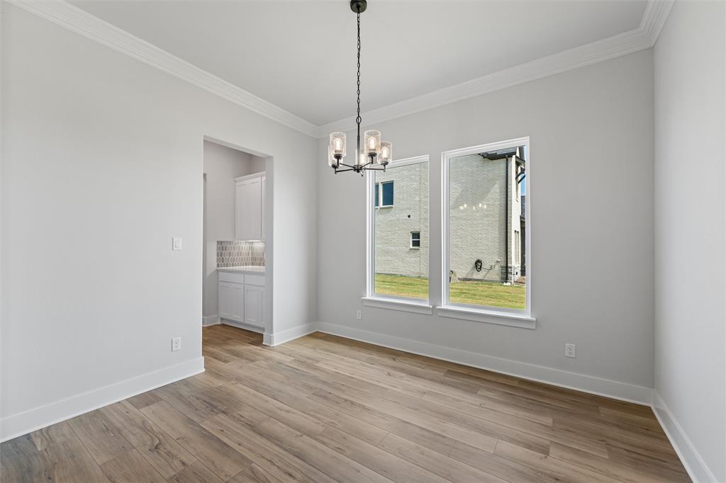 12108 Crystal Drive Krum, TX 76249 - Photo 11 of 40 a view of an empty room with window and wooden floor