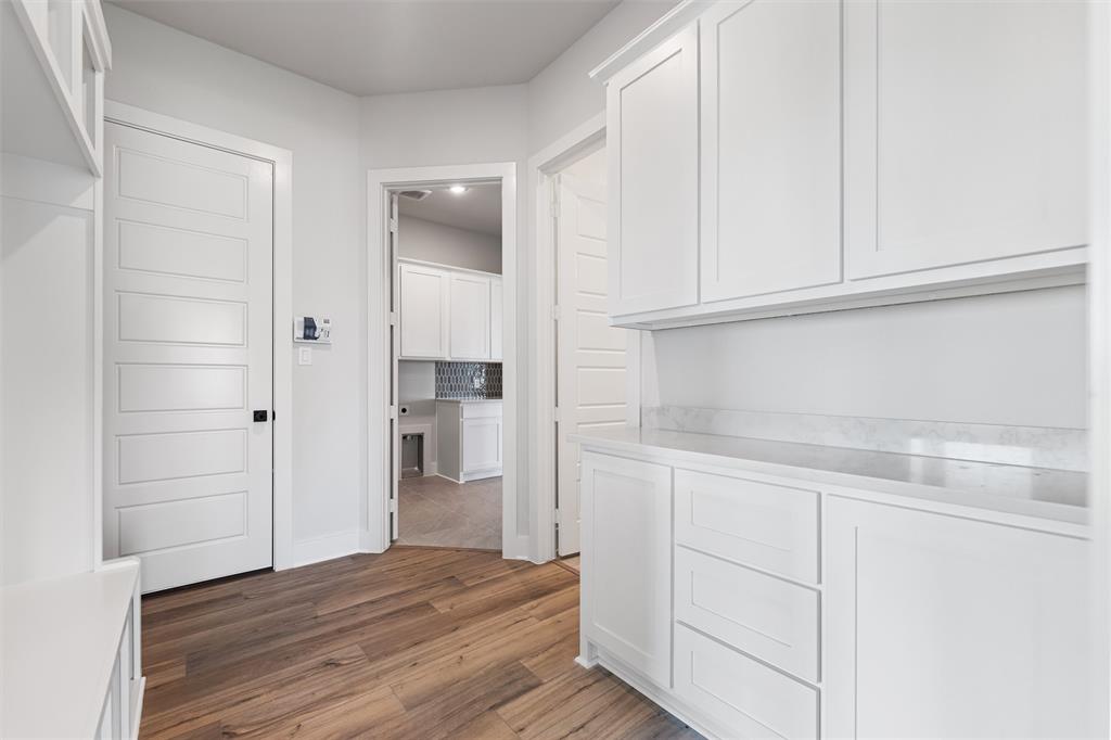12108 Crystal Drive Krum, TX 76249 - Photo 14 of 40 a view of kitchen with cabinets and wooden floor
