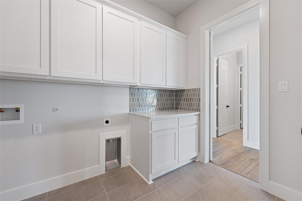 12108 Crystal Drive Krum, TX 76249 - Photo 17 of 40 a kitchen with white cabinets and a sink