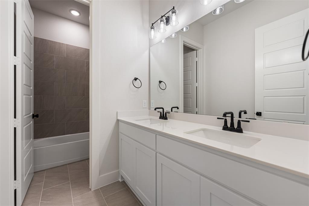 12108 Crystal Drive Krum, TX 76249 - Photo 21 of 40 a bathroom with a bathtub sink vanity and mirror