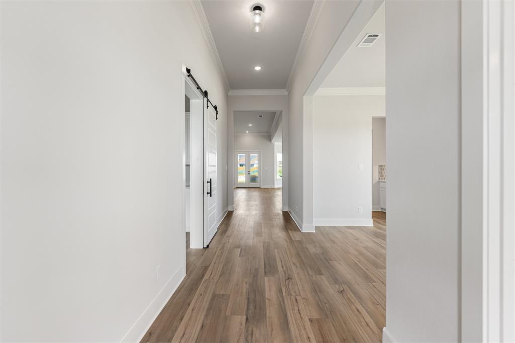 12108 Crystal Drive Krum, TX 76249 - Photo 8 of 40 a view of a hallway with wooden floor